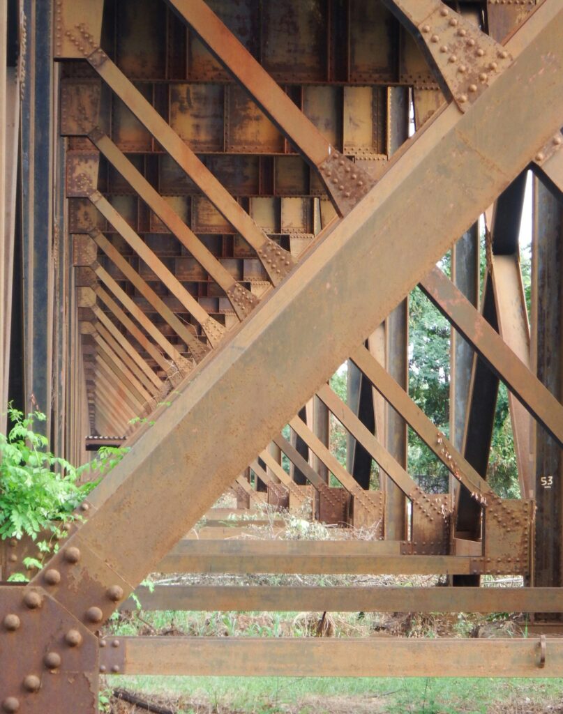 Close-up view of a rusty steel train trestle in Richmond, Virginia, showcasing industrial design.